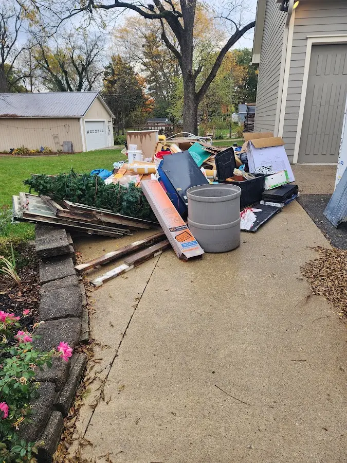 Dumpster being loaded with debris for 3 Yard Dumpster Rental in Kirtland